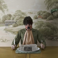man at dinner table with a face of a dog